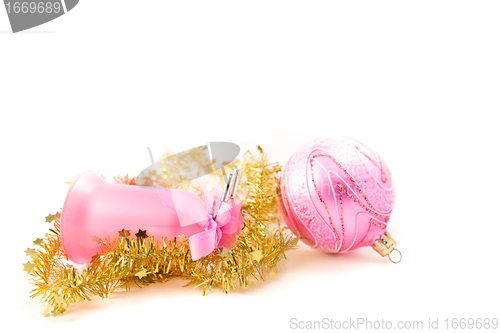 Image of golden tinsel with pink glass decoration