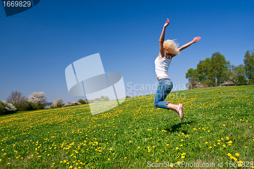 Image of happy young woman on meadow