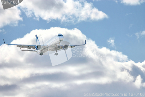 Image of Modern airplane in the sky near airport. 