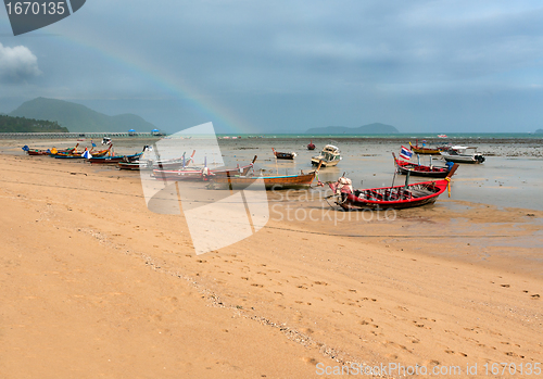 Image of ebb of the sea a boat on the rocks