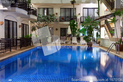 Image of pool with blue water in a cozy hotel