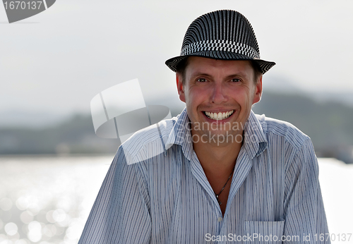 Image of portrait of a smiling man in a hat