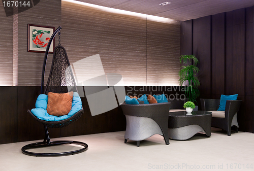 Image of chair hanging on a chain in the hotel lobby sofa 