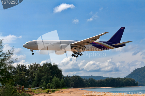 Image of passenger aircraft over the beach