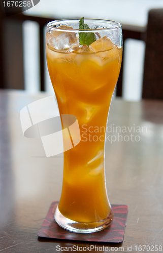 Image of cocktail, mango juice with ice cubes