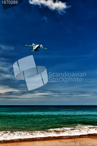 Image of propeller aircraft comes in to land