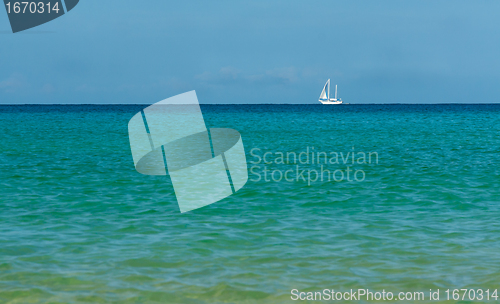 Image of white sailboat on the azure sea