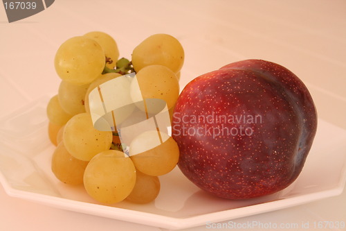 Image of Grapes and plum on small plate