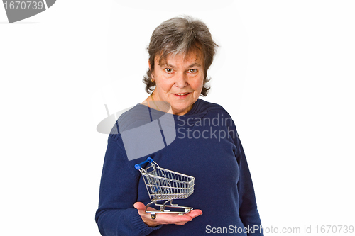 Image of Female senior holding empty model shopping trolley