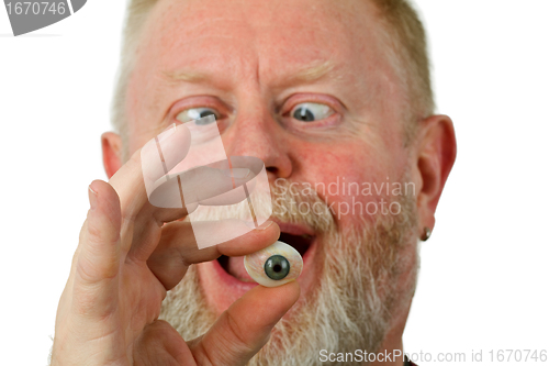 Image of Oculist holding glass eye 