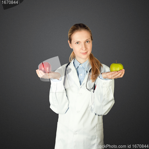 Image of female doctor with two apples