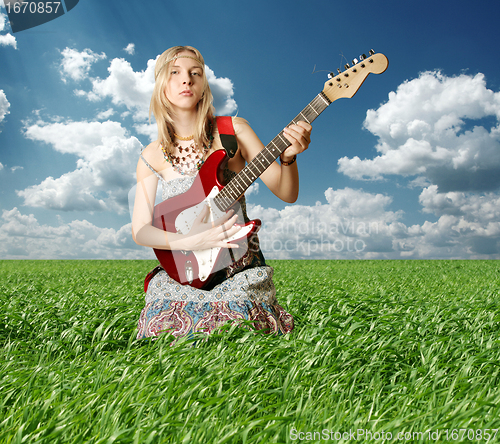 Image of hippie girl with the guitar outdoor