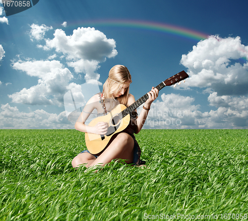 Image of hippie girl with the guitar outdoor