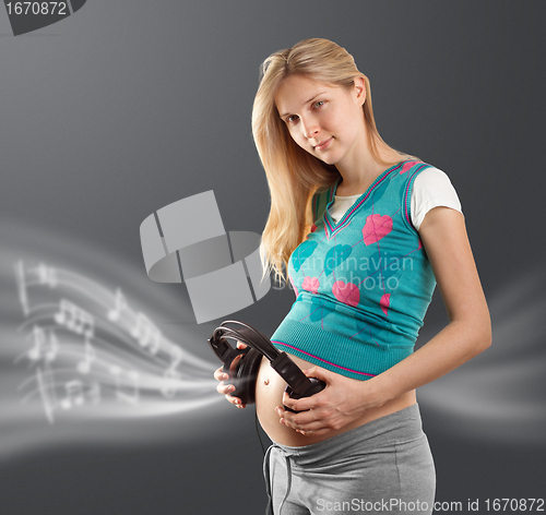 Image of pregnant female with headphones