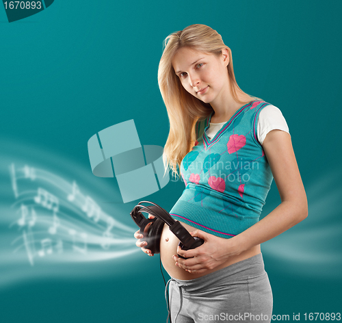 Image of pregnant female with headphones