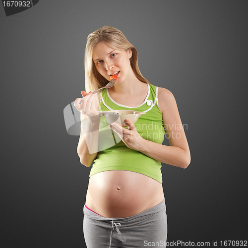 Image of tender pregnant female with salad