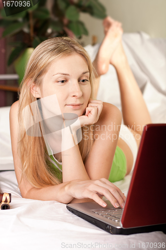 Image of woman in bed with laptop
