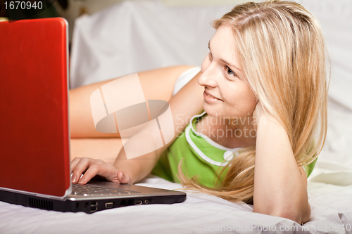 Image of woman in bed with laptop