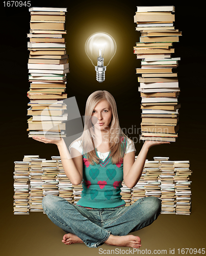 Image of woman in lotus pose with many books in her hands and bulb