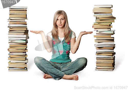 Image of woman in lotus pose with many books near