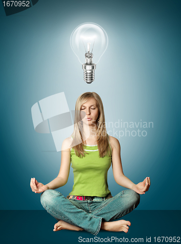 Image of woman meditation in lotus pose with bulb