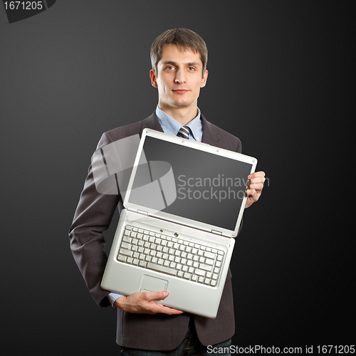 Image of businessman with open laptop in his hands
