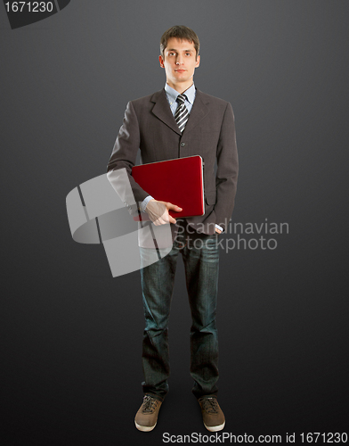 Image of male in suit with laptop in his hands