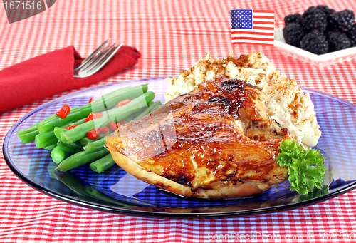 Image of Barbecue chicken breast, string beans and potato salad garnished