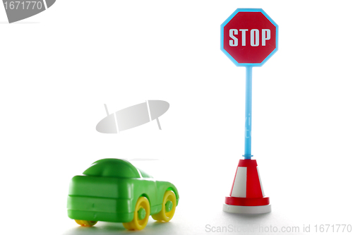 Image of Car behind stop road sign