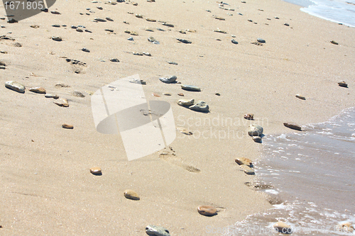 Image of Footprints at the beach among the stones