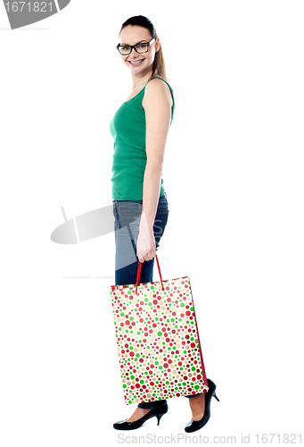 Image of Beautiful shopping woman happy holding shopping bags