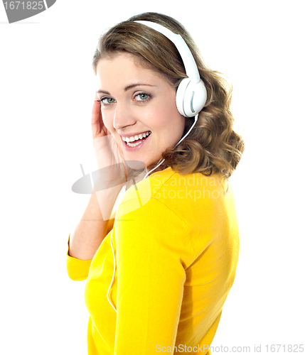 Image of Attractive teenager tuned into music