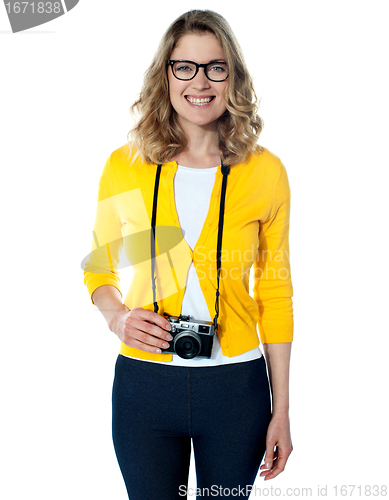 Image of Attractive young girl with a camera