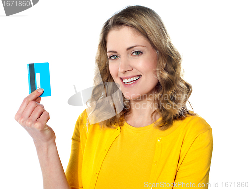 Image of Portrait of young smiling woman holding credit card