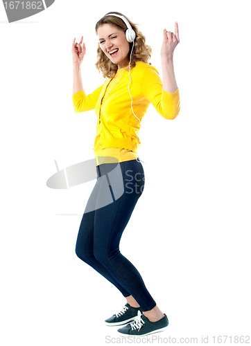 Image of Hip hop woman with headphones enjoying music