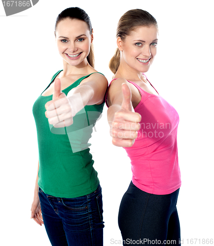 Image of Smiling pretty girls gesturing thumbs-up