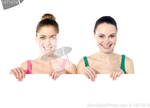 Image of Teen girls holding white board