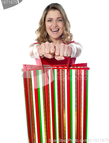 Image of Excited teenager holding shopping bags