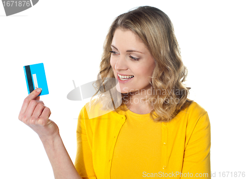 Image of Attractive female holding her credit card