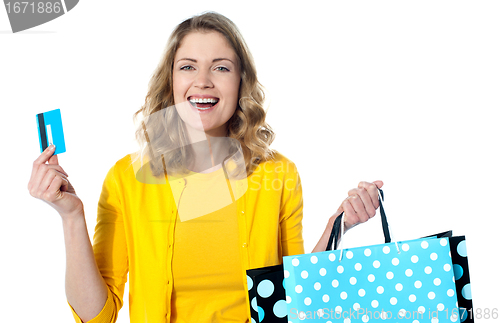 Image of Happy shopaholic female laughing