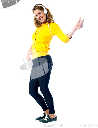 Image of Rock style woman with headphones listening to music