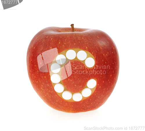 Image of Red apple with vitamin c pills over white background - concept