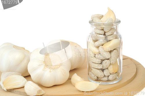 Image of Garlic and herbal supplement pills isolated, alternative medicine concept