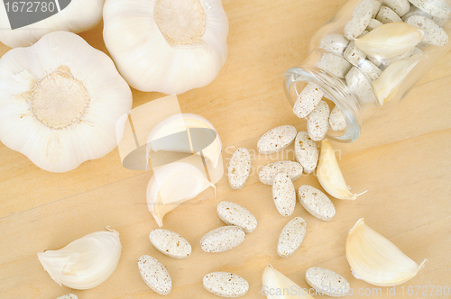 Image of Garlic and herbal supplement pills, alternative medicine concept