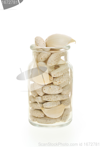 Image of Garlic and herbal supplement pills isolated, alternative medicine concept