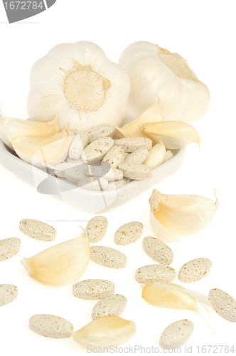 Image of Garlic and herbal supplement pills isolated, alternative medicine concept