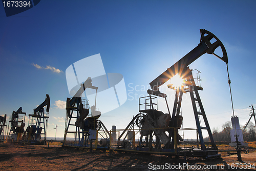 Image of working oil pumps silhouette