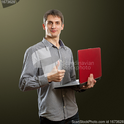 Image of male with laptop in his hands well done