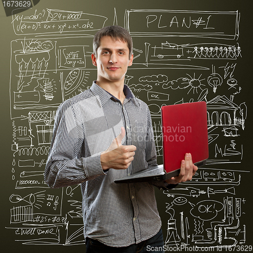 Image of male with laptop in his hands well done