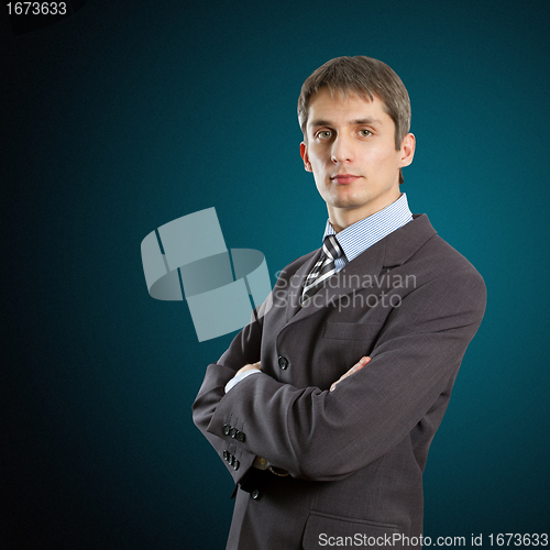 Image of male in suit with folded hands